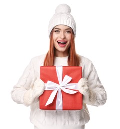 Photo of Young woman in hat and sweater with Christmas gift on white background