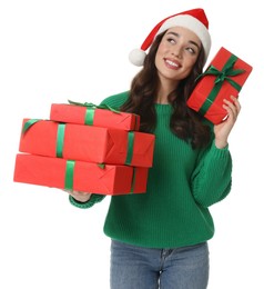 Photo of Beautiful young woman in Santa hat with Christmas gifts isolated on white