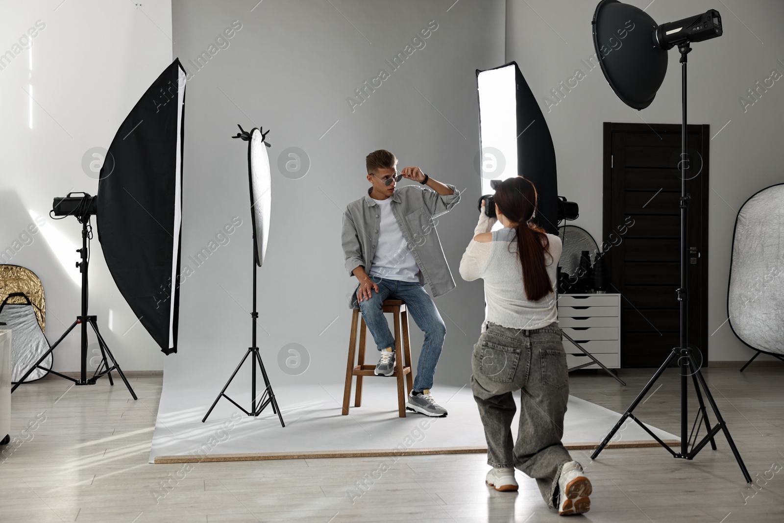 Photo of Photographer working with model in professional photo studio