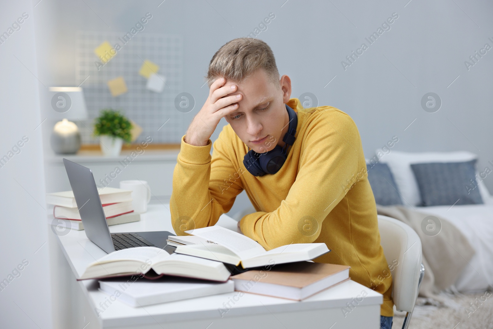 Photo of Student preparing for exam at table indoors