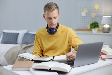 Photo of Student preparing for exam at table indoors