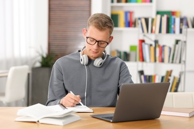 Photo of Student preparing for exam at table indoors