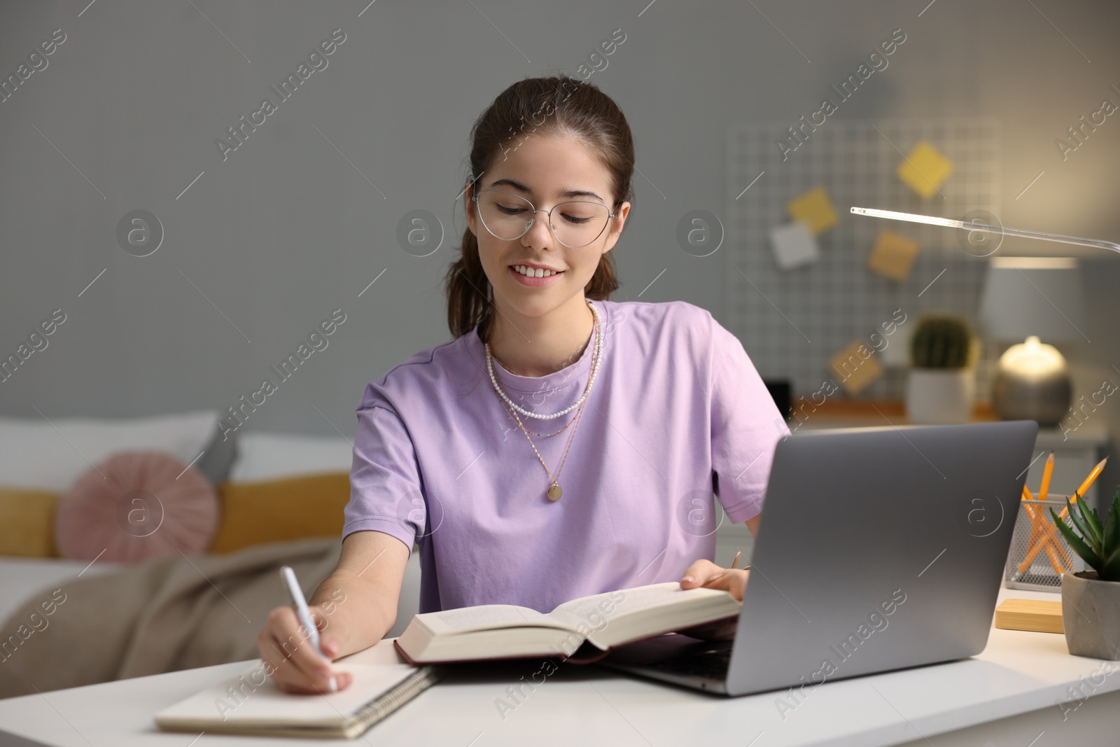 Photo of Student preparing for exam at table indoors