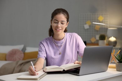 Photo of Student preparing for exam at table indoors