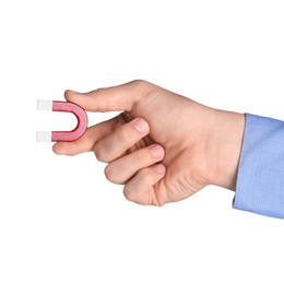 Photo of Man with horseshoe magnet on white background, closeup