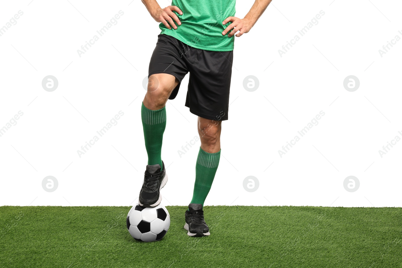 Photo of Football player with soccer ball on artificial grass against white background, closeup