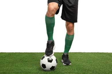 Photo of Football player with soccer ball on artificial grass against white background, closeup