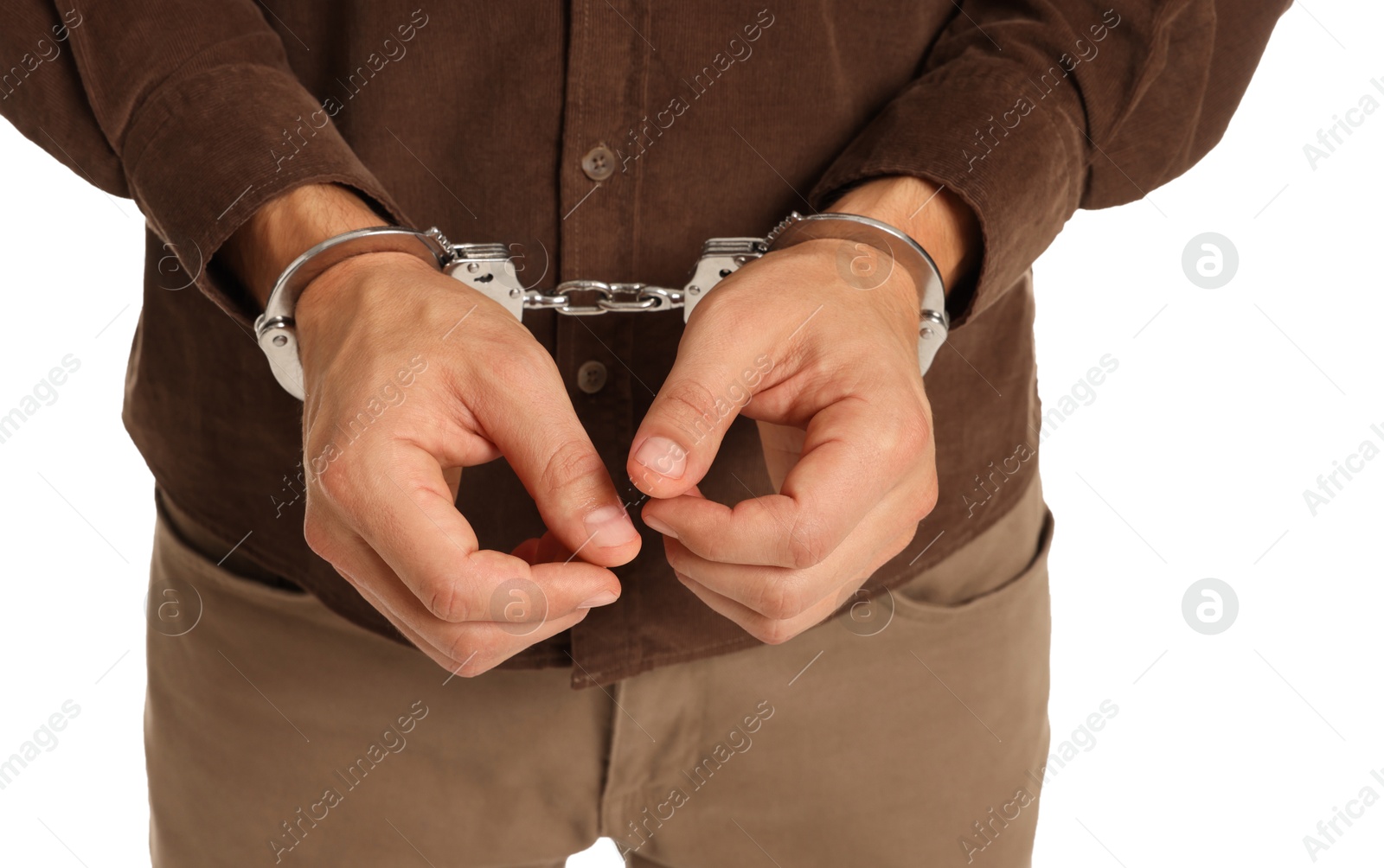 Photo of Man in metal handcuffs on white background, closeup