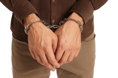 Photo of Man in metal handcuffs on white background, closeup