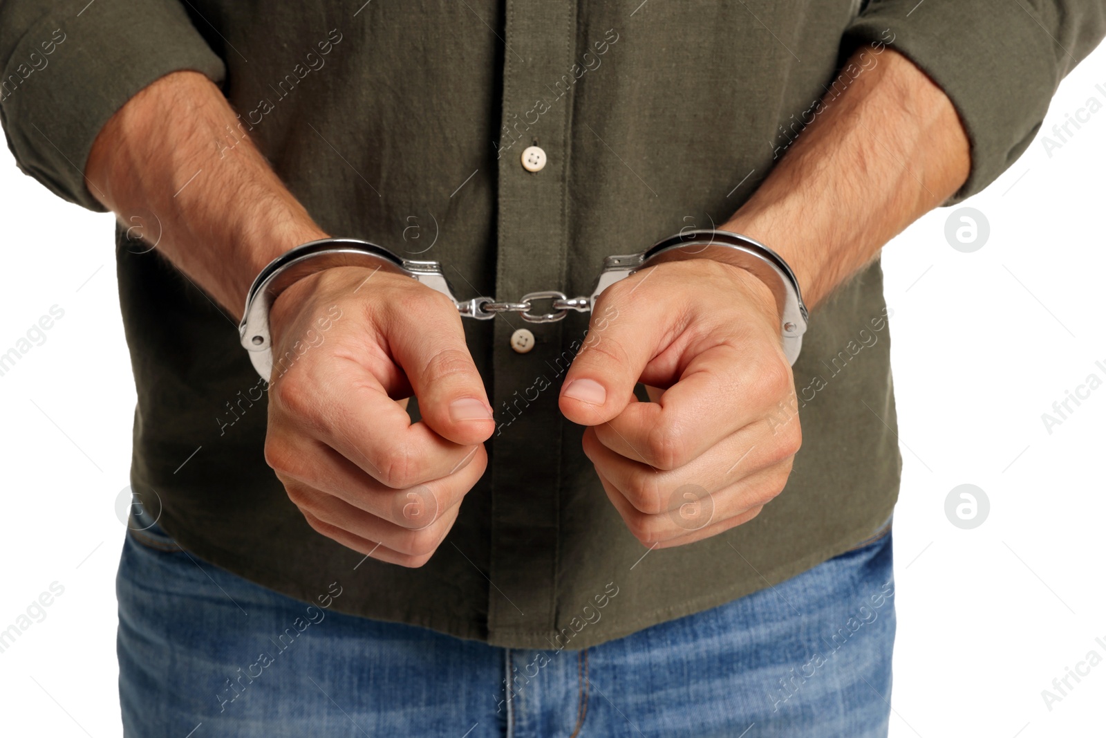 Photo of Man in metal handcuffs on white background, closeup