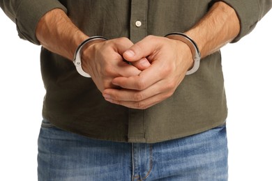 Photo of Man in metal handcuffs on white background, closeup