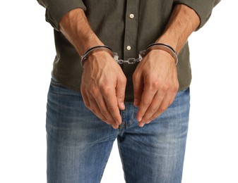 Man in metal handcuffs on white background, closeup