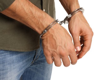 Photo of Man in metal handcuffs on white background, closeup