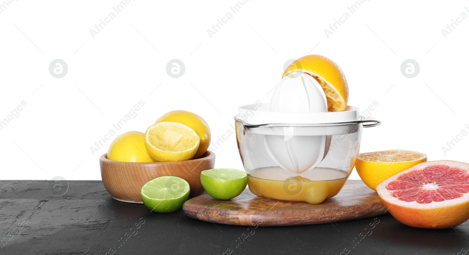 Photo of Plastic juicer and different fresh citrus fruits on black table against white background