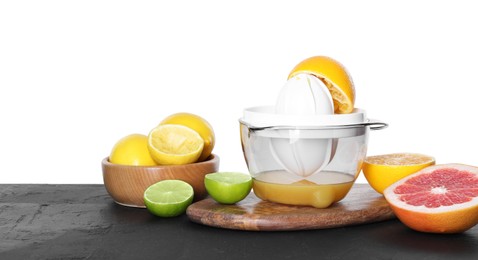 Photo of Plastic juicer and different fresh citrus fruits on black table against white background