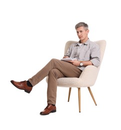 Photo of Professional psychologist with notebook sitting on chair against white background