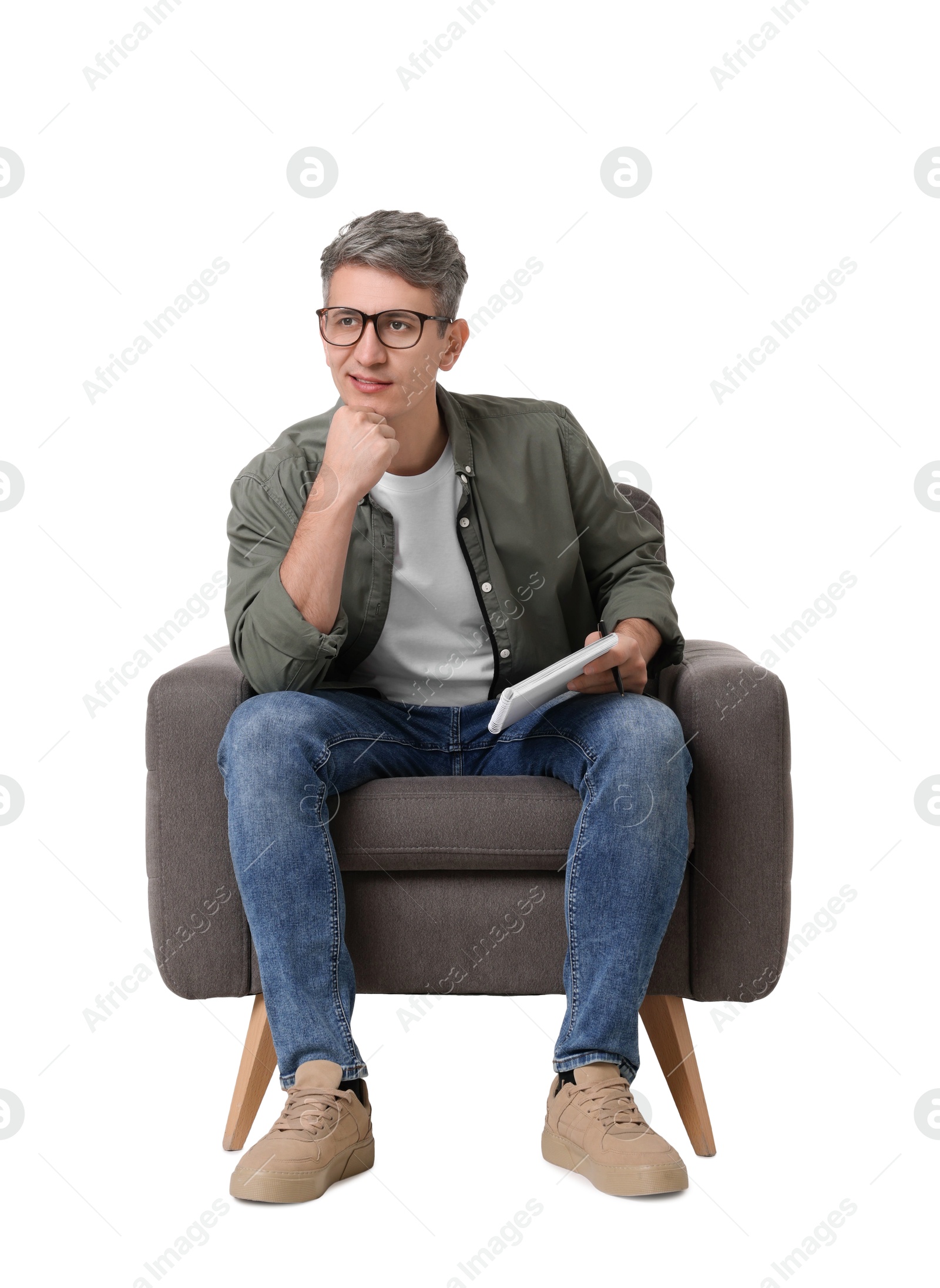 Photo of Professional psychologist with notebook sitting on chair against white background