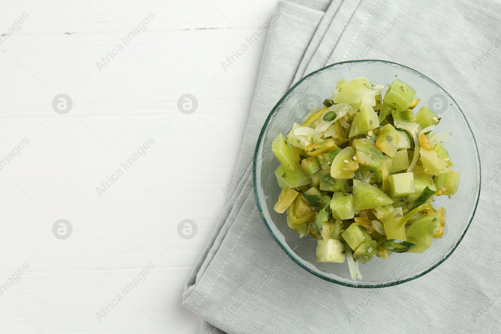 Photo of Delicious salsa (Pico de gallo) in bowl on white wooden table, top view. Space for text