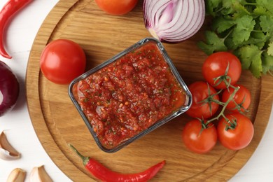 Photo of Delicious salsa sauce and ingredients on white wooden table, flat lay