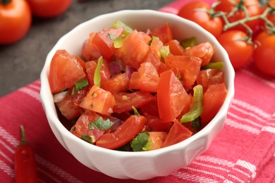 Photo of Delicious salsa (Pico de gallo) in bowl on grey table, closeup