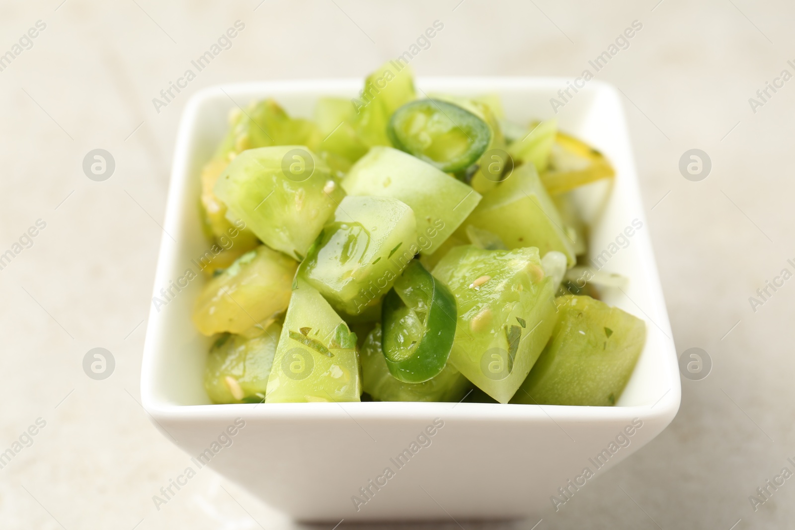 Photo of Delicious salsa (Pico de gallo) in bowl on light table, closeup