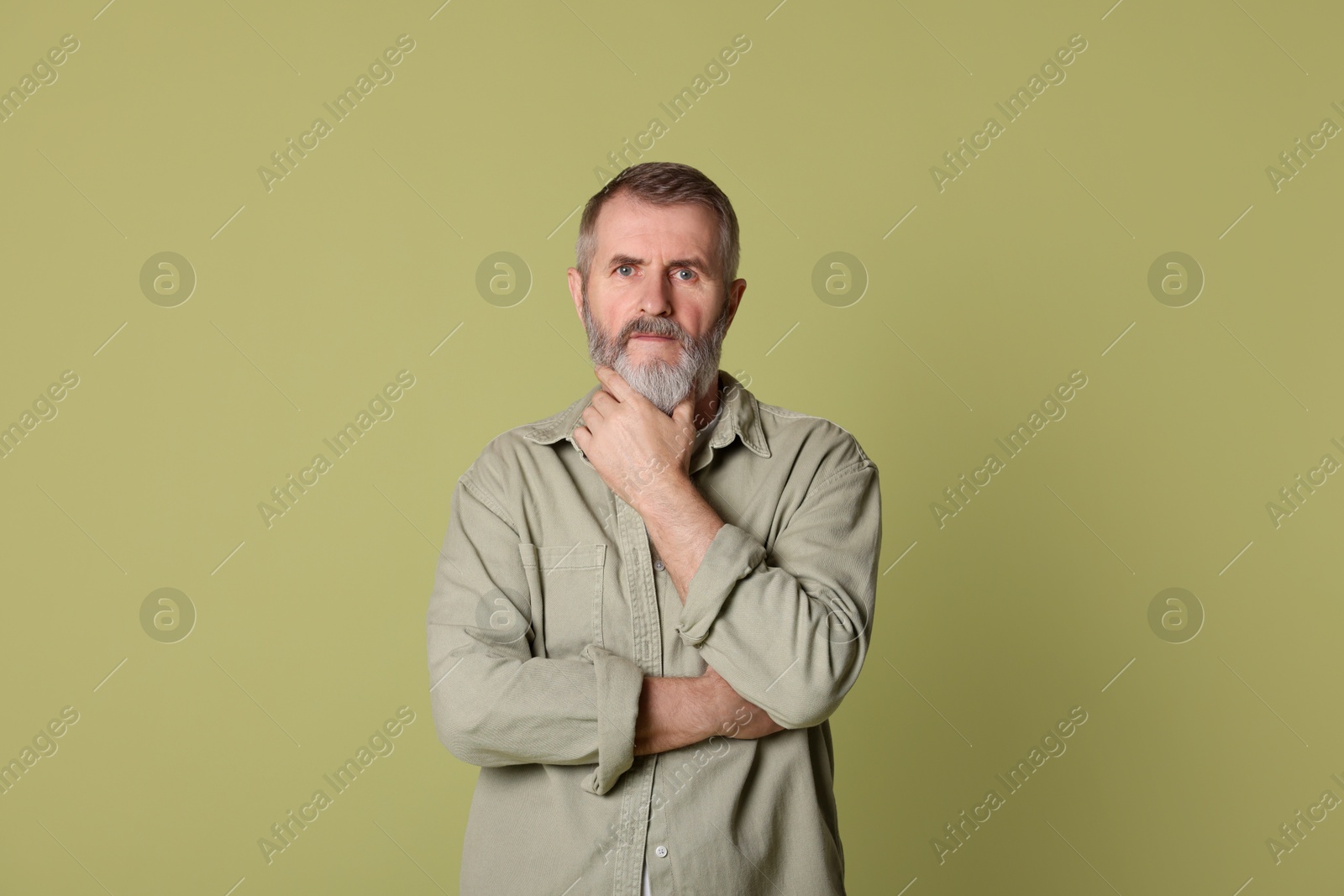 Photo of Portrait of senior man on green background