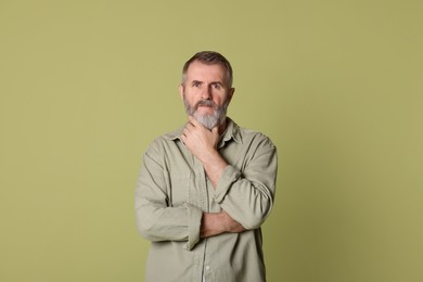 Photo of Portrait of senior man on green background