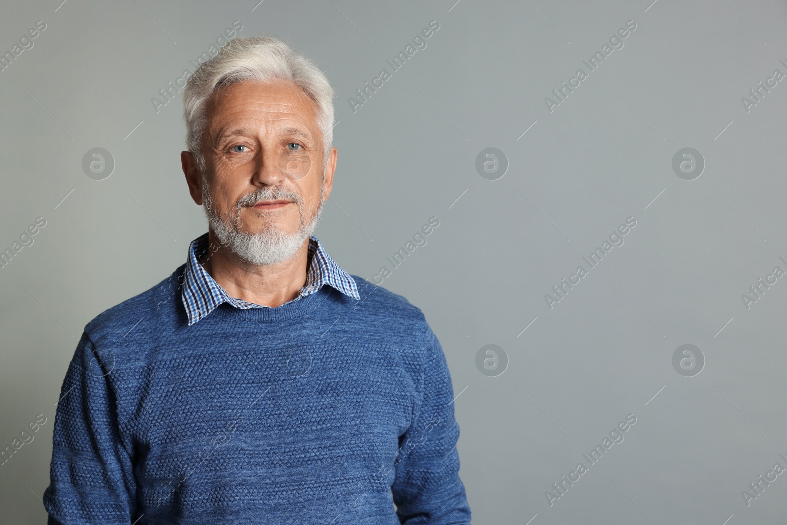 Photo of Portrait of senior man on grey background, space for text