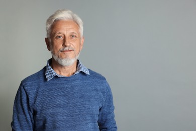 Photo of Portrait of senior man on grey background, space for text