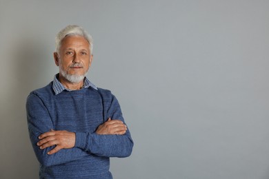 Photo of Portrait of senior man on grey background, space for text