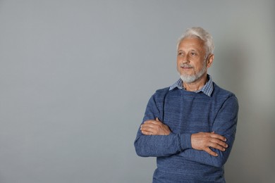 Photo of Portrait of senior man on grey background, space for text