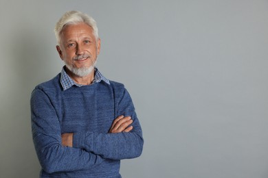 Photo of Portrait of senior man on grey background, space for text