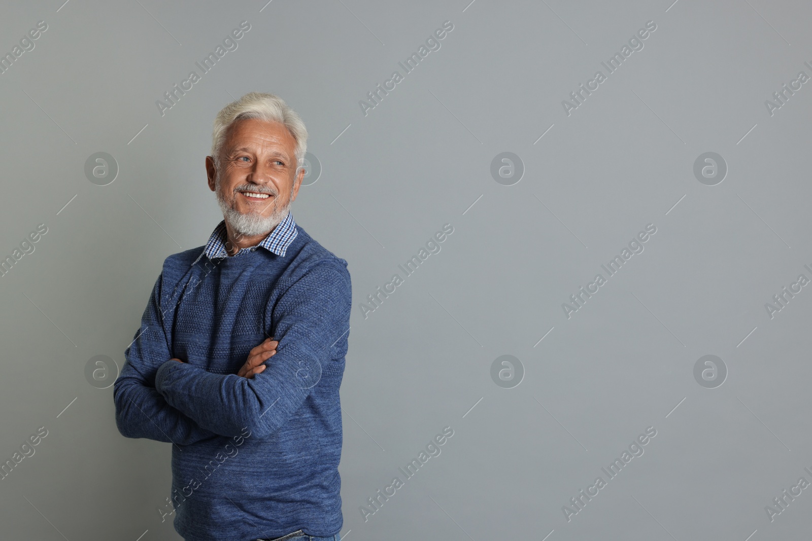 Photo of Portrait of senior man on grey background, space for text