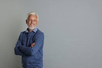 Photo of Portrait of senior man on grey background, space for text