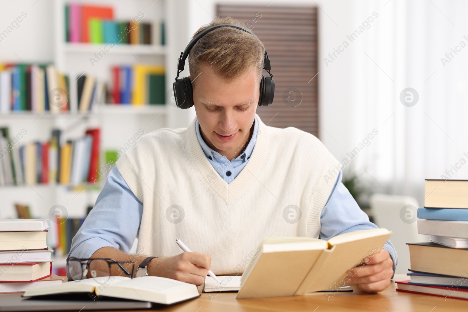 Photo of Student preparing for exam at table indoors