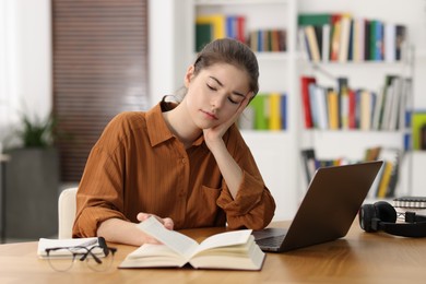 Photo of Student preparing for exam at table indoors