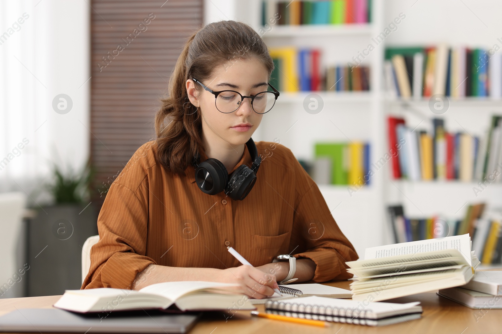 Photo of Student preparing for exam at table indoors