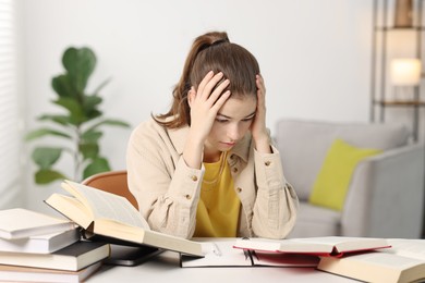 Student preparing for exam at table indoors