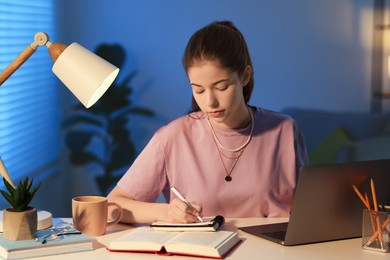 Photo of Student preparing for exam at table indoors