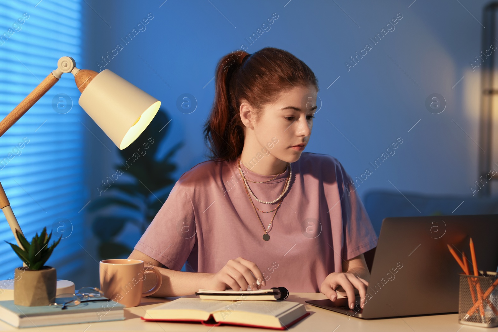 Photo of Student preparing for exam at table indoors