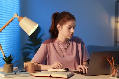 Photo of Student preparing for exam at table indoors