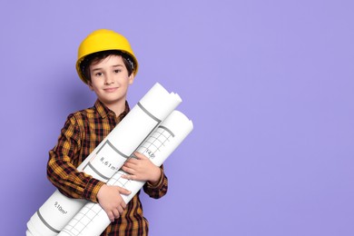 Photo of Boy with house plan pretending to be architect on violet background. Dreaming of future profession