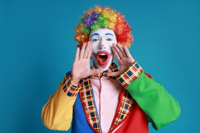 Photo of Portrait of clown screaming on blue background