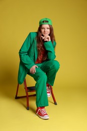 Photo of Fashion portrait of red-haired teenage girl on golden background