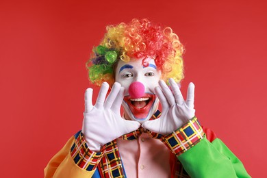 Photo of Portrait of happy clown on red background