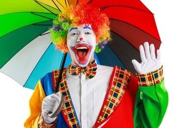 Photo of Happy clown with colorful umbrella on light background