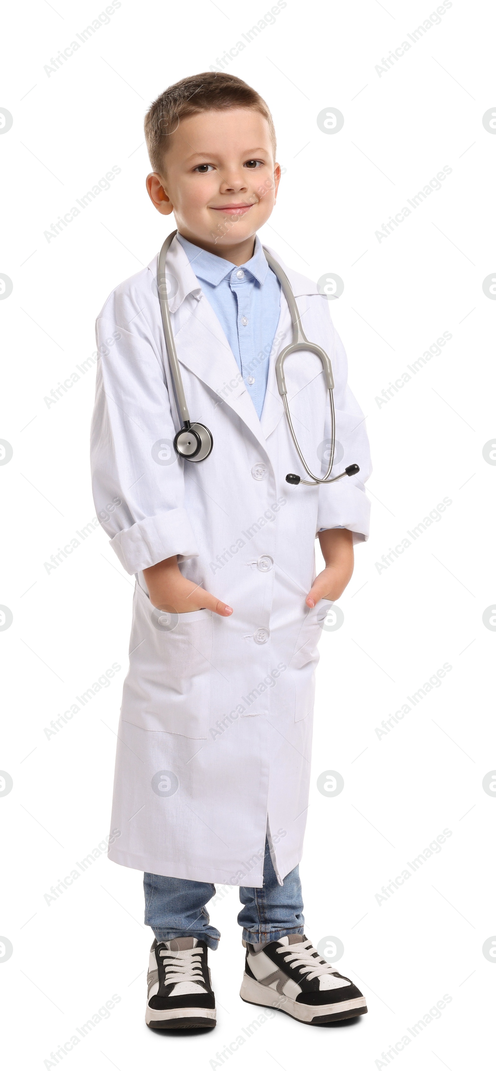 Photo of Little boy with stethoscope pretending to be doctor on white background. Dreaming of future profession