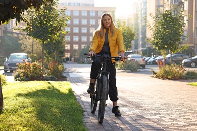 Photo of Woman with bicycle outdoors on sunny day