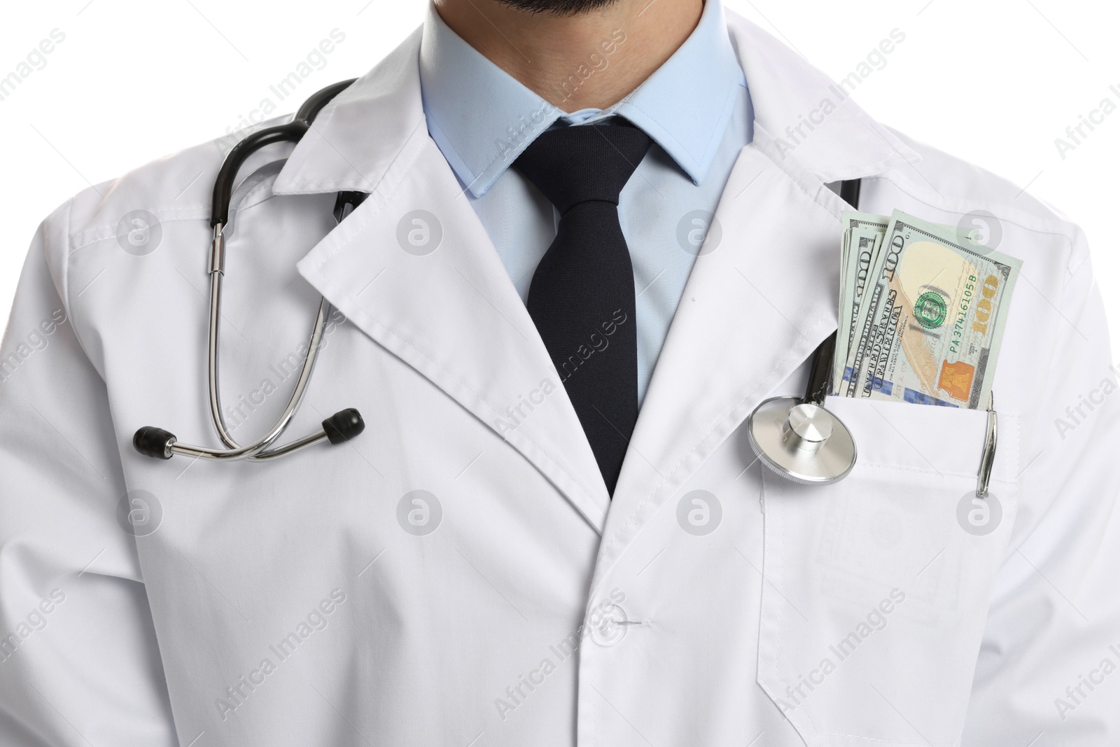 Photo of Corruption concept. Doctor with dollar banknotes on white background, closeup