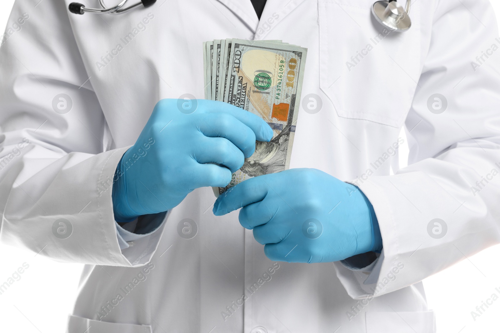 Photo of Corruption concept. Doctor putting dollar banknotes into his coat on white background, closeup